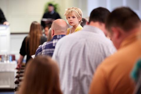 Little girl looking back during the service